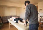 professional massage therapist treating patient in clinic