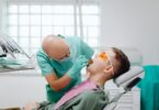 a dentist checking a patient s teeth