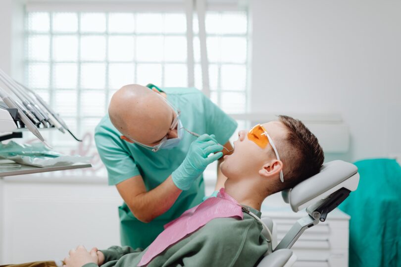 a dentist checking a patient s teeth