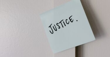 the word justice written on paper