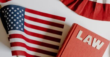 american flag beside a law book on white background