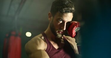 close up photography of man wearing boxing gloves