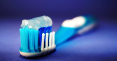 closeup and selective focus photography of toothbrush with toothpaste