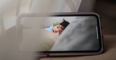 screen of mobile phone with sleeping baby