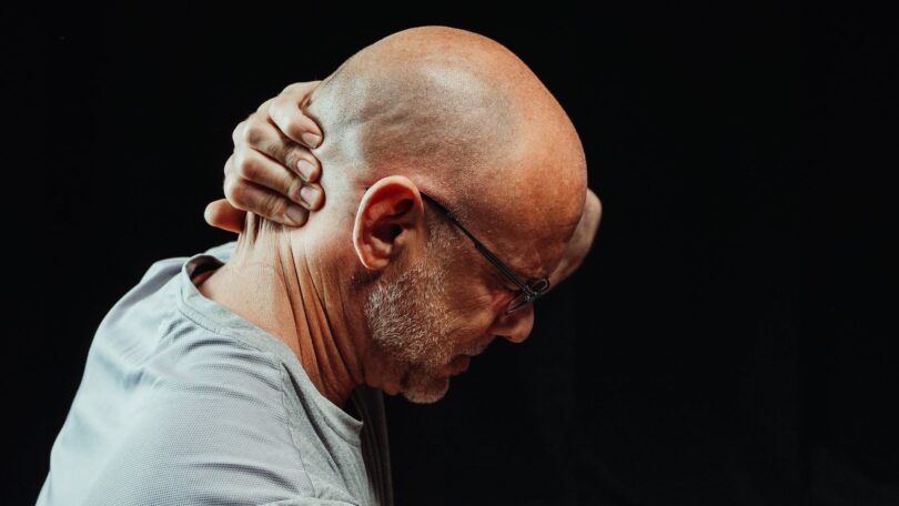 close up photo of man having a neck pain