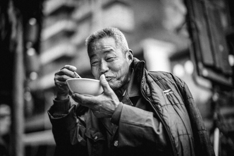 old man eating on bowl