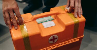 a person holding a first aid kit