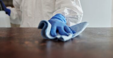 close up photo of person cleaning the table