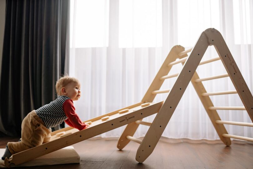 boy climbing on wooden ladder