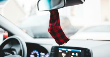 mask hanging on mirror in car