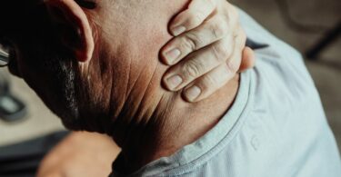 close up photo of a man having a neck pain