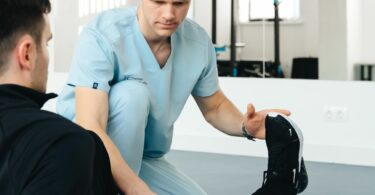 physiotherapist and patient stretching leg