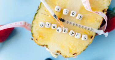 letter dices and insulin on top of a sliced pineapple
